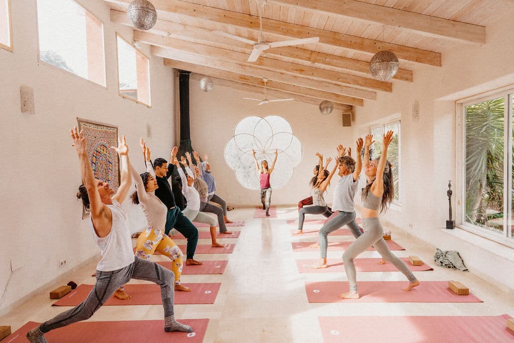 Yoga class with hands raised in morning practice